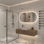 De verlichting schijnt bij deze ovale badkamer spiegel vanachter de spiegel fraai en sfeervol over de wand